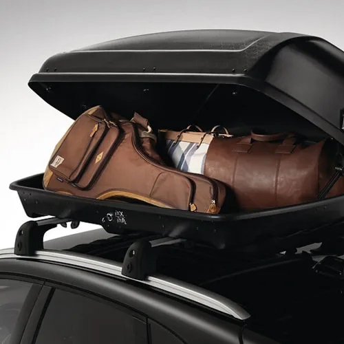 Zu sehen ist eine Dachbox, gefüllt mit einer Gitarre und Koffern. 